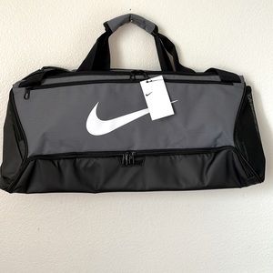 Black and gray Nike Med Duffle Bag